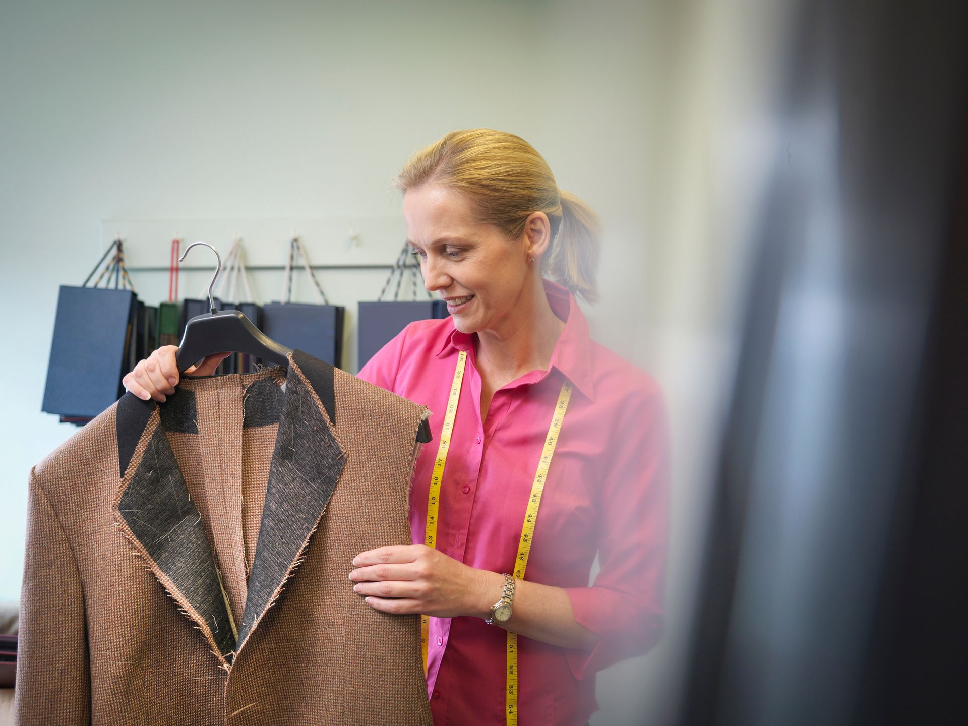 Lady Wearing Pink Holding Dress — Wentworthville, NSW — Avesta Tailoring