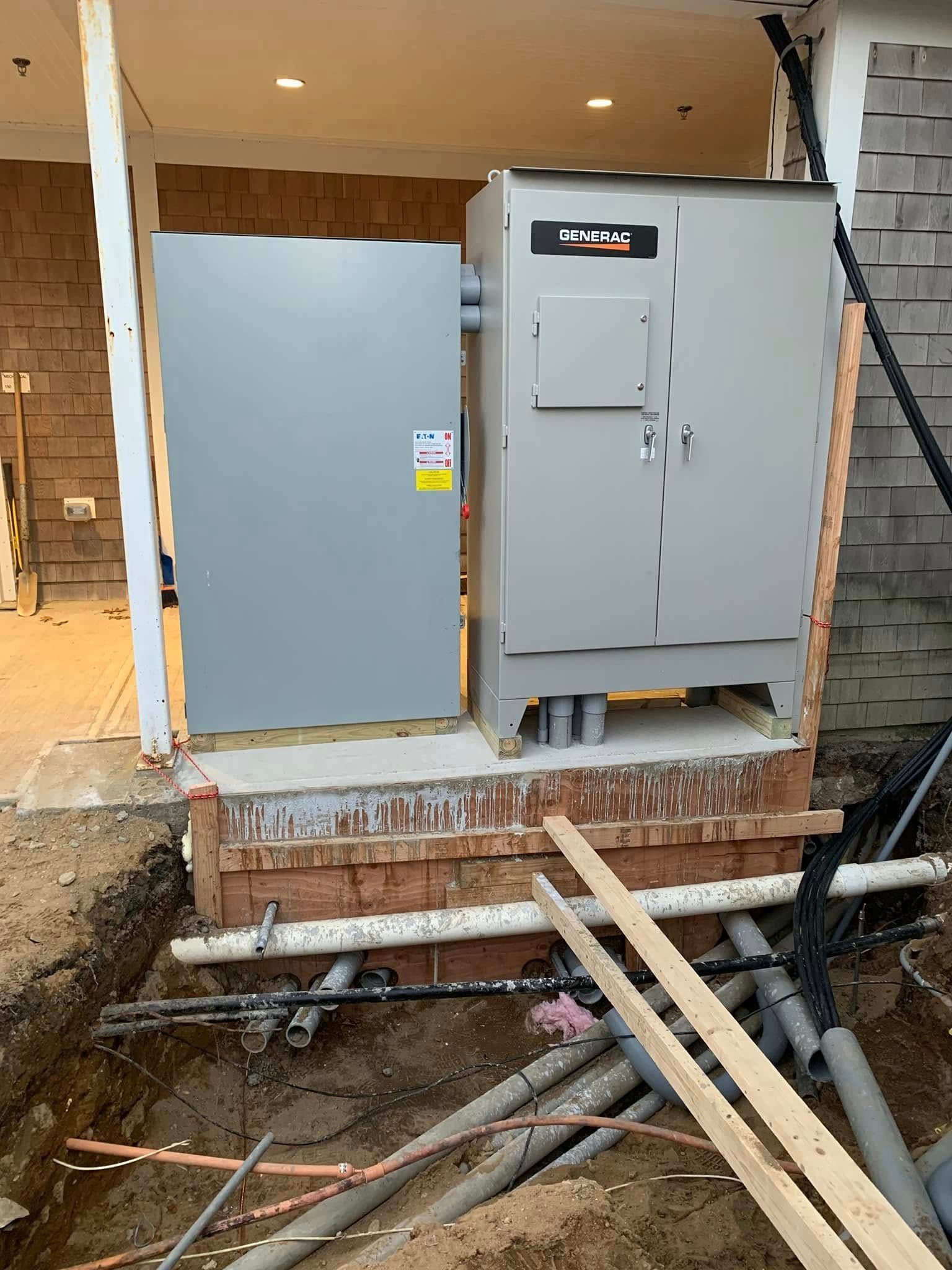 Gray utility cabinets on a porch with exposed pipes and construction debris nearby