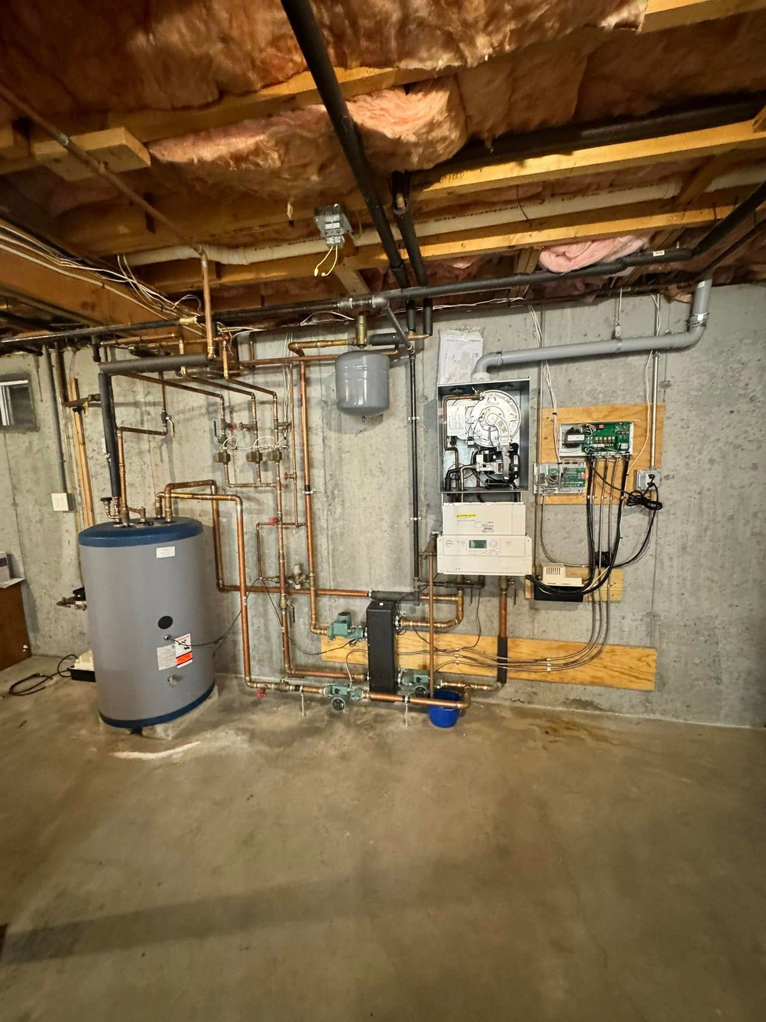 Basement utility room with water heater, furnace, exposed pipes, and concrete floor