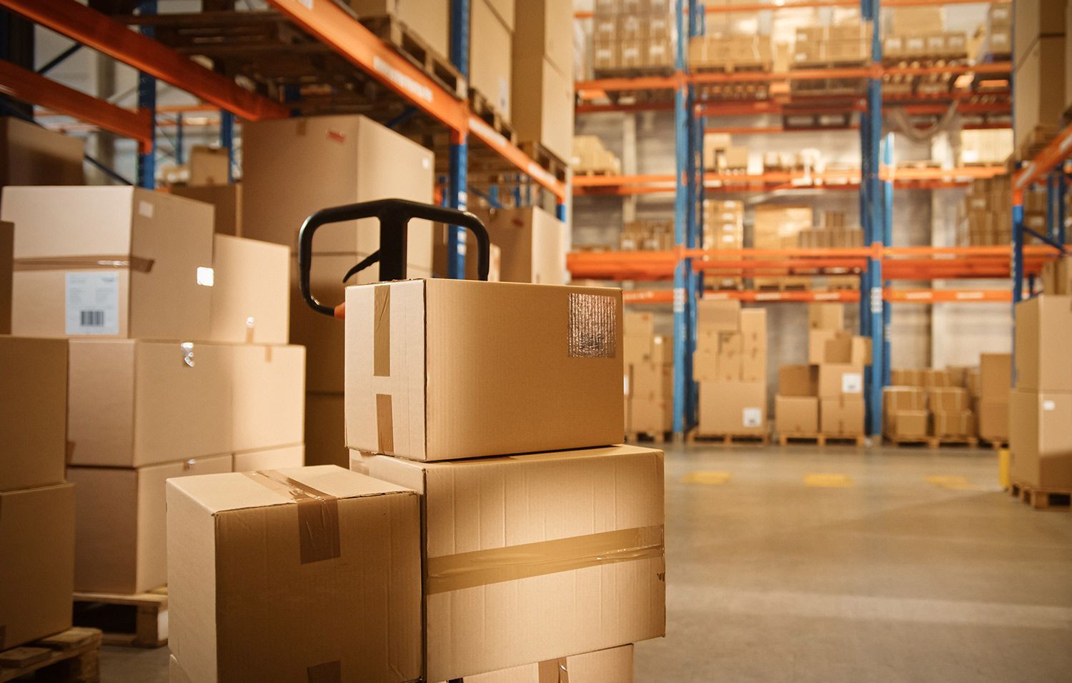 Warehouse aisle with stacked cardboard boxes