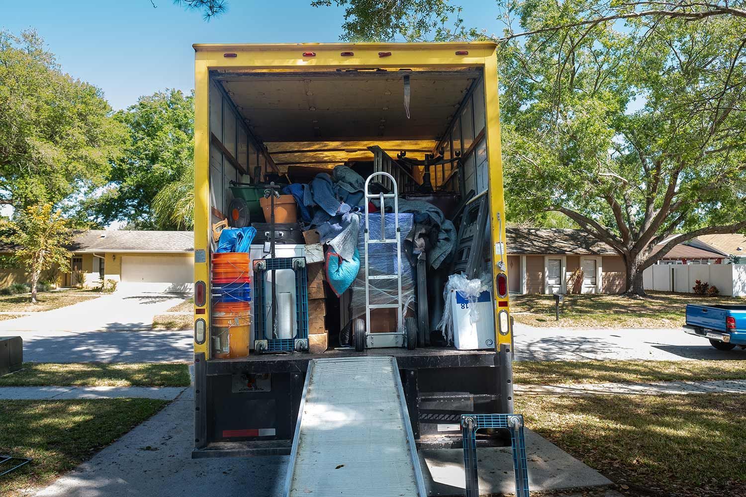 Open moving truck packed with boxes and furniture