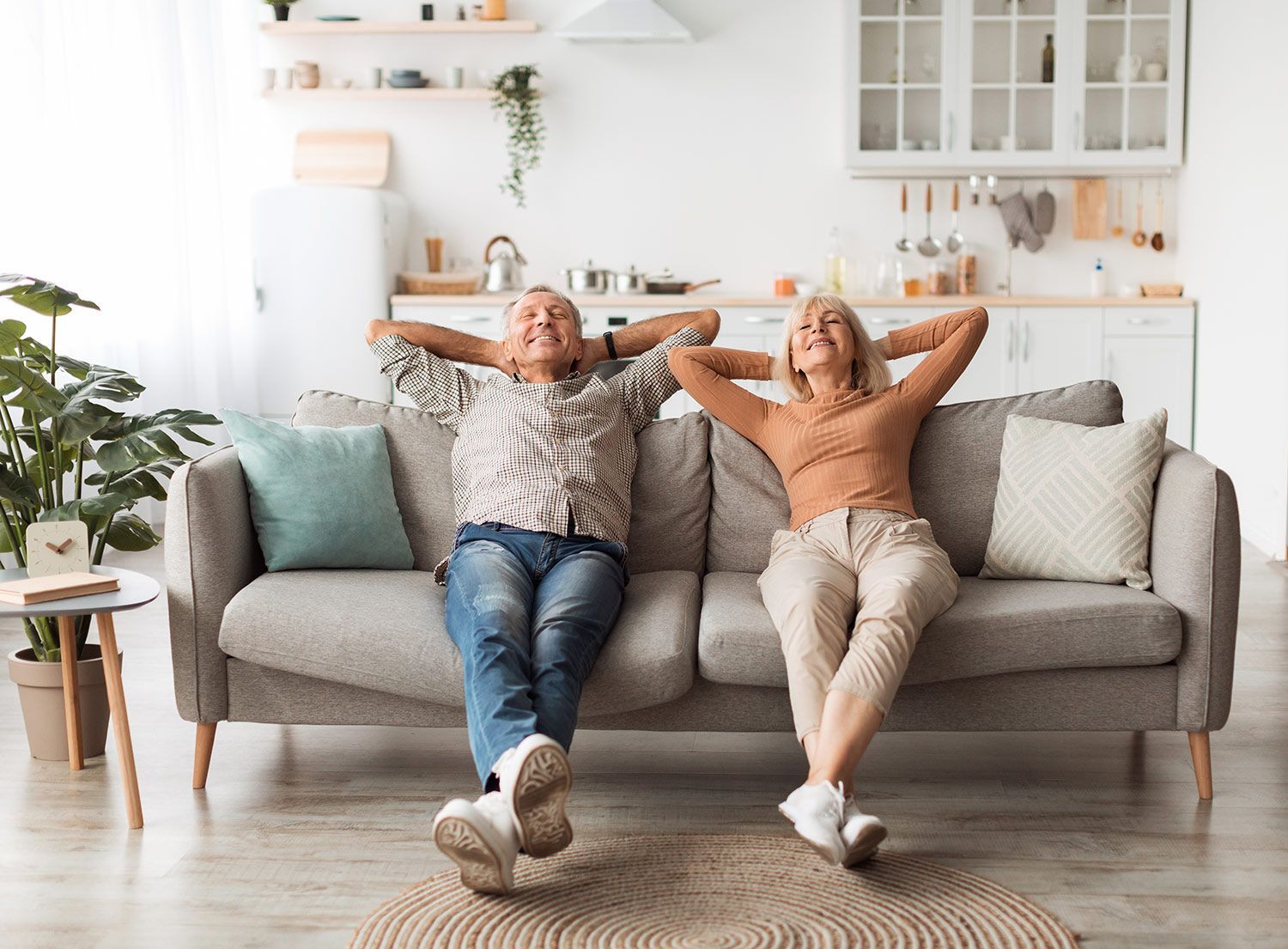 Senior couple relaxing on a sofa in living room