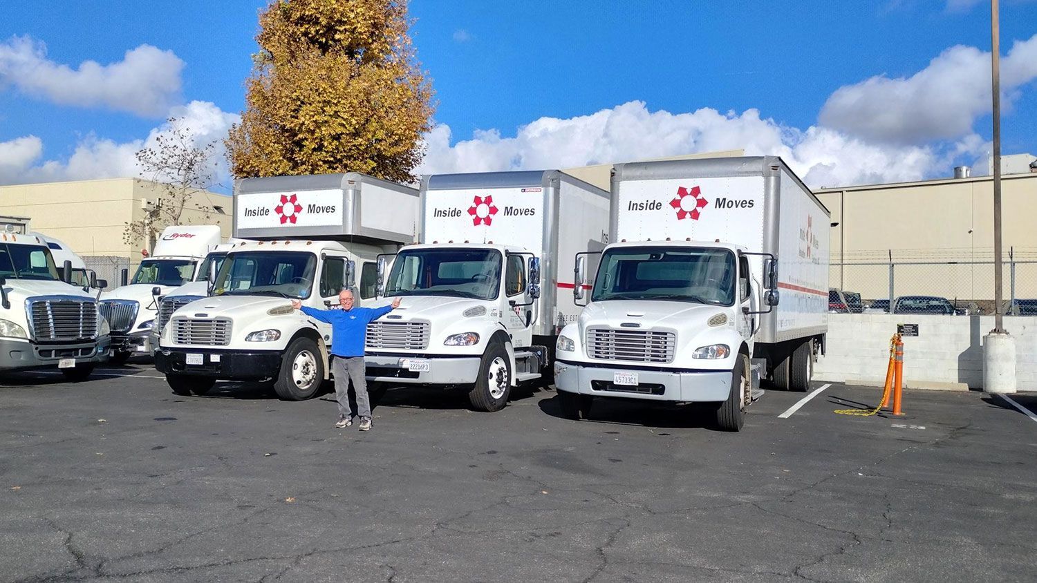 Moving trucks parked on a wide property