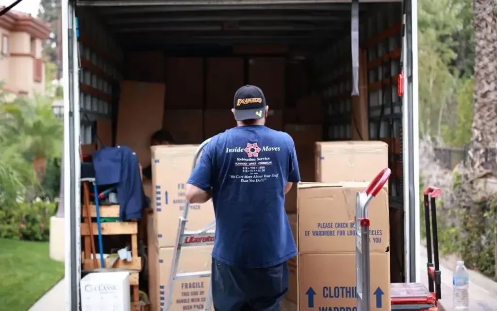 Mover loading cardboard boxes into a truck