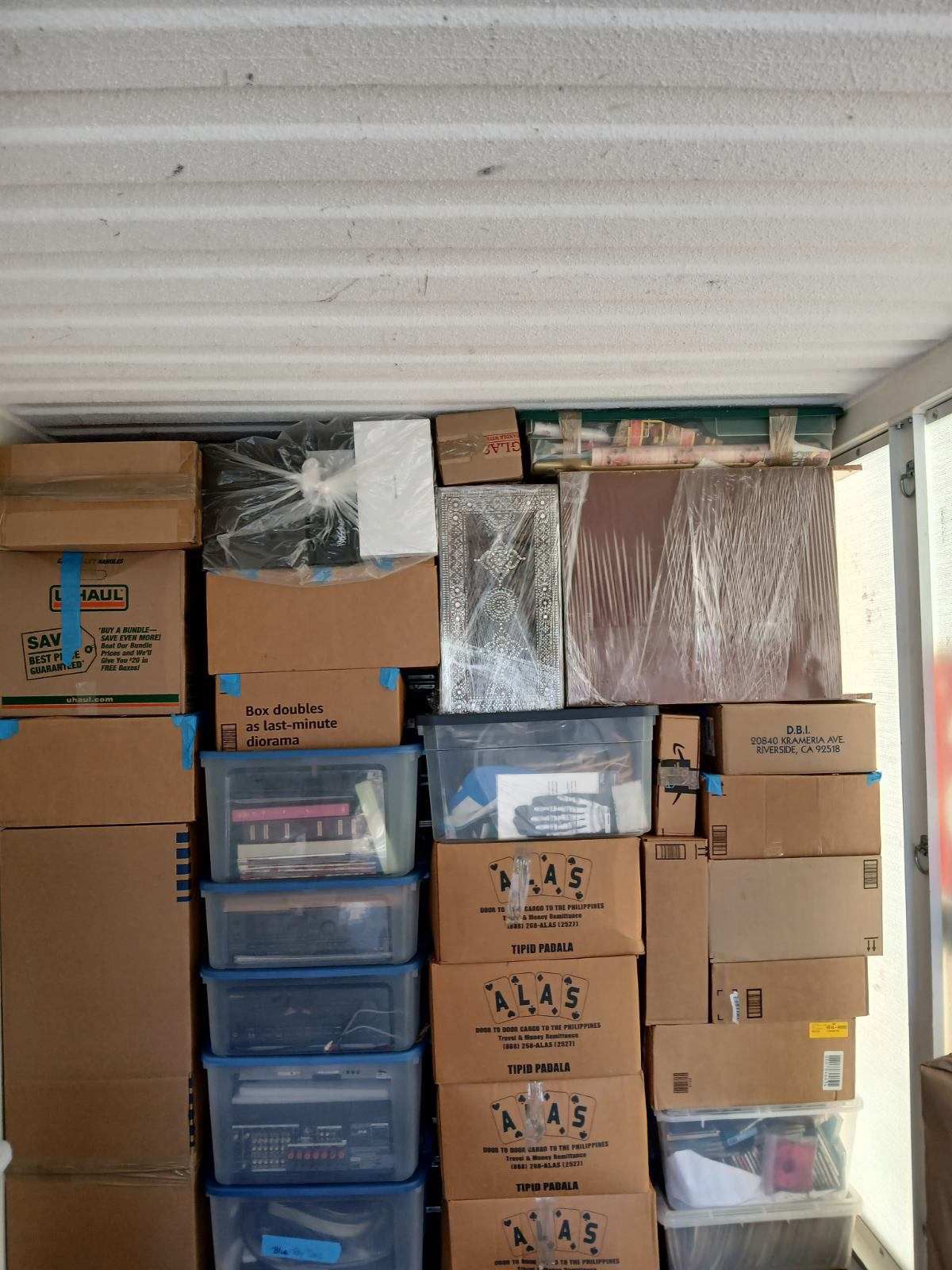 Cardboard boxes and plastic bins in storage