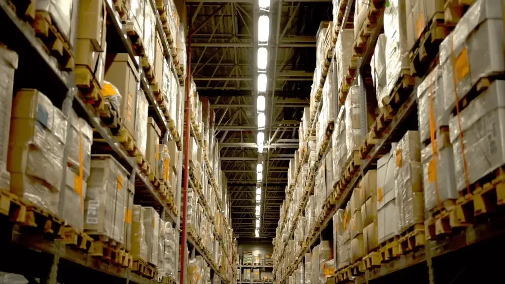 Tall warehouse aisles stacked with wrapped boxes