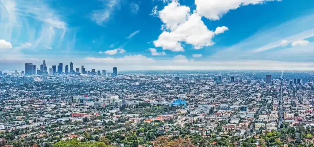 Panoramic city skyline under a bright blue sky
