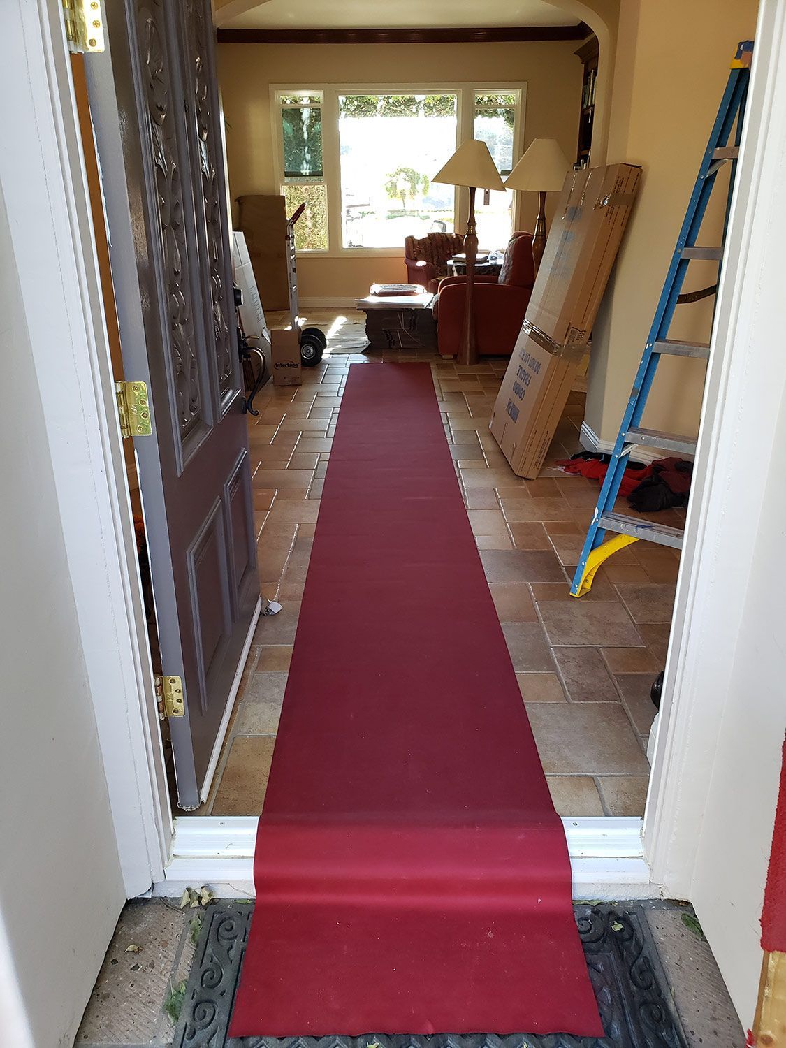 Red carpet runner through a doorway into a hallway