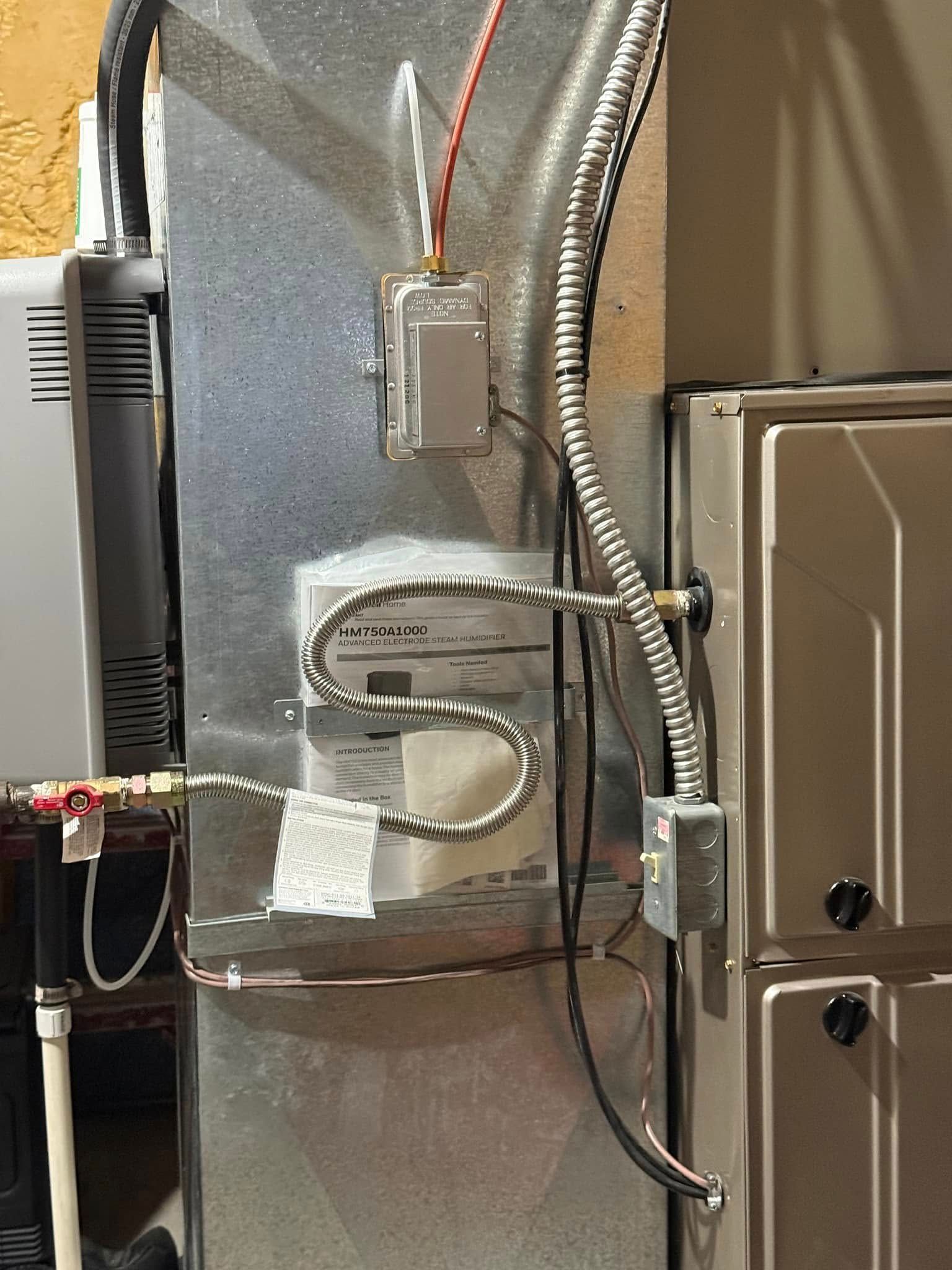 HVAC ductwork with insulated wiring and a metal electrical box in a utility room
