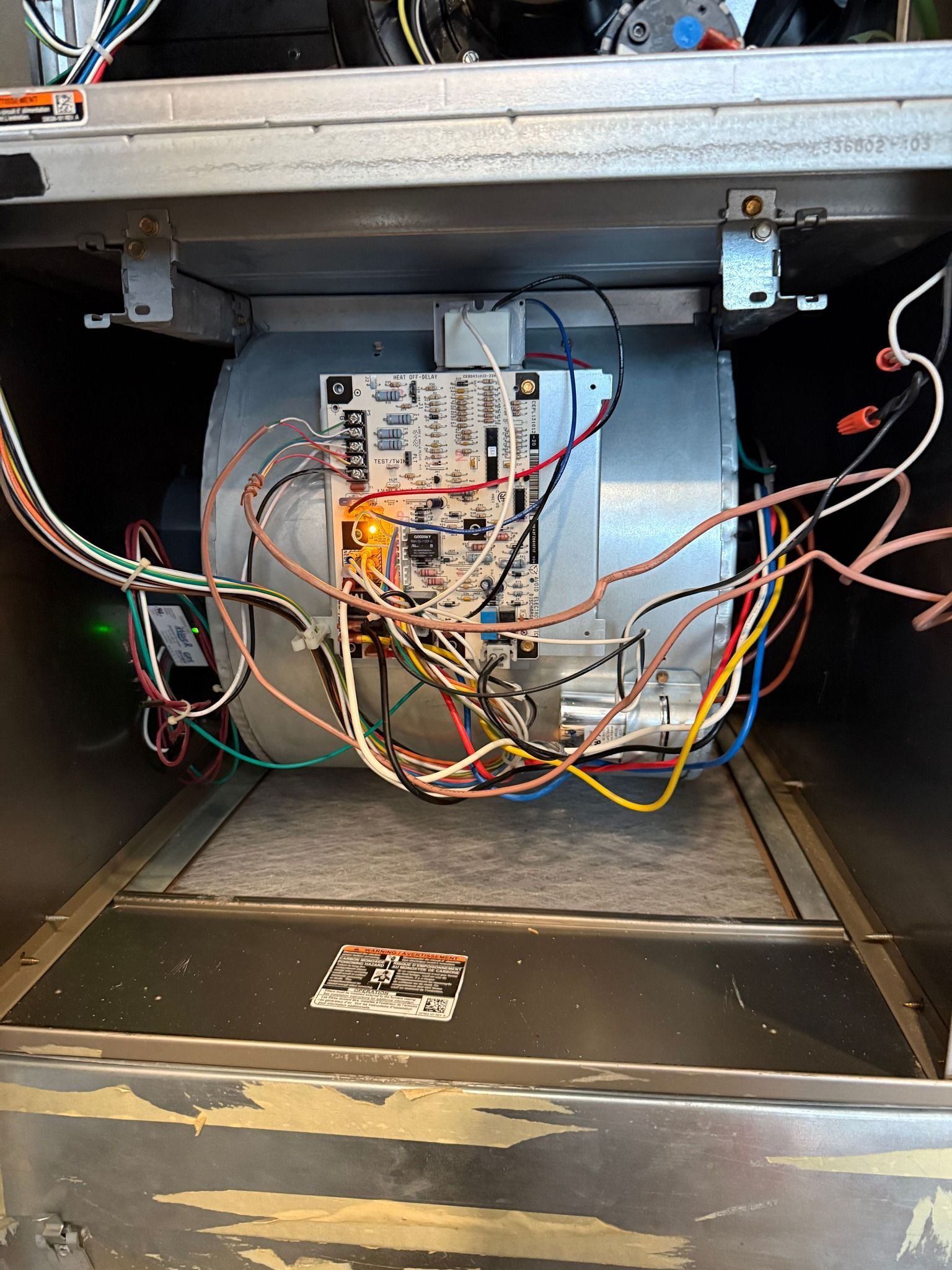 Inside an open arcade machine cabinet, exposed wiring and control boards are visible.