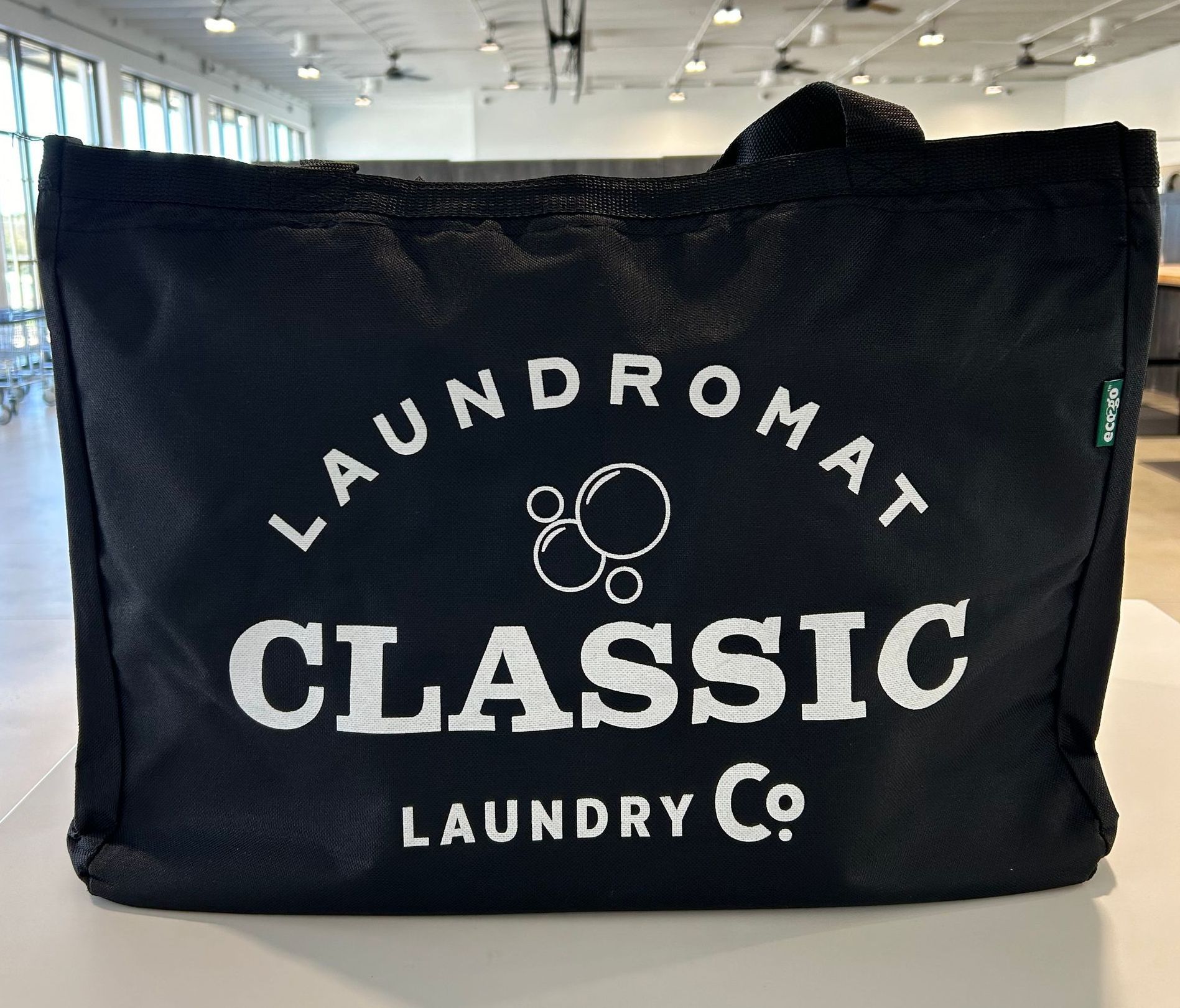 Hard bottom logo laundry bag.