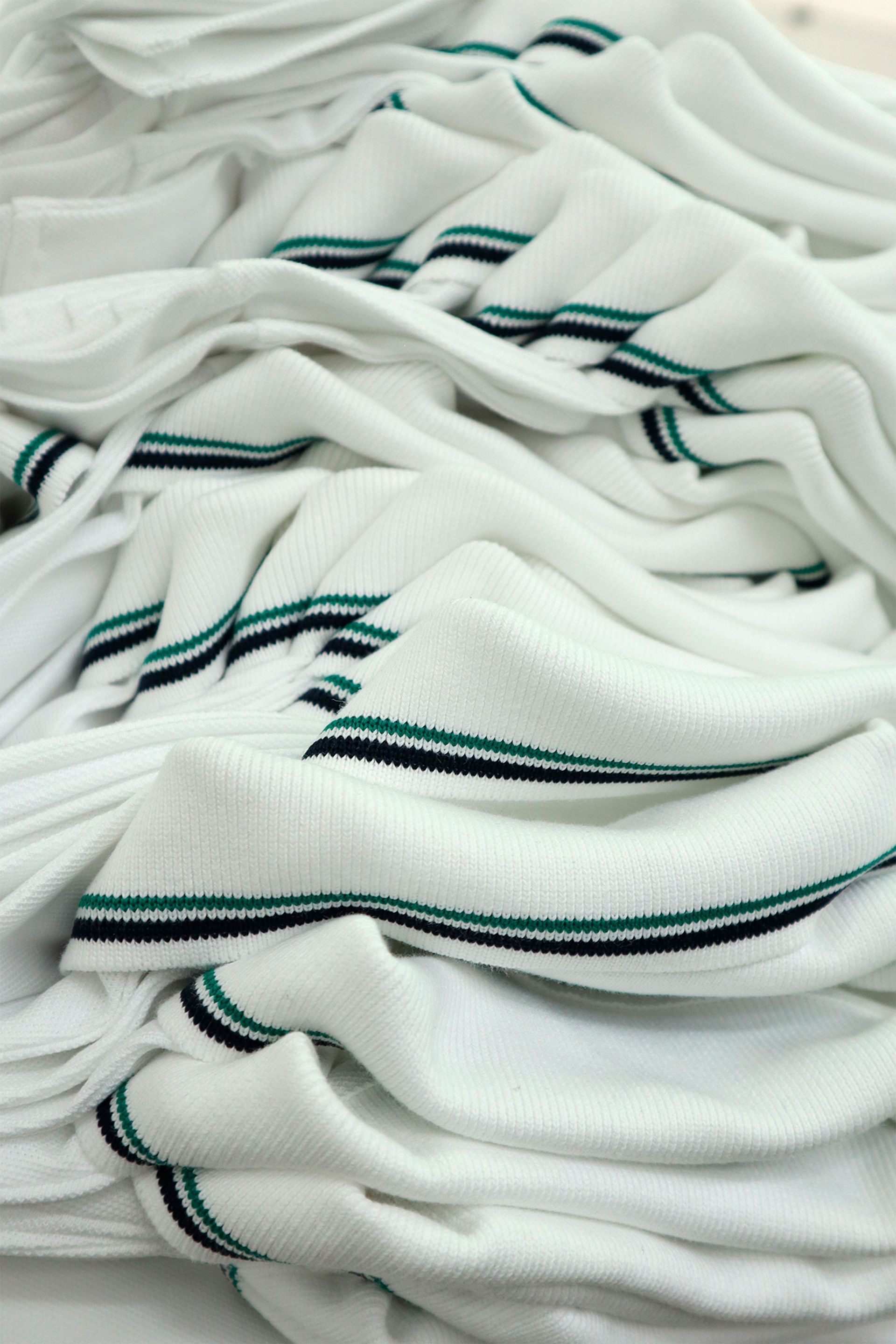 Stacked polo shirts with matching striped collars.