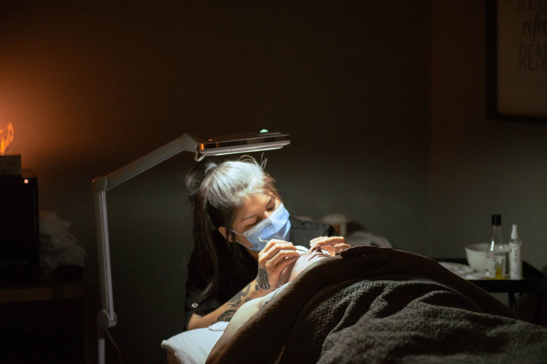 A woman is getting a facial treatment at a beauty salon.