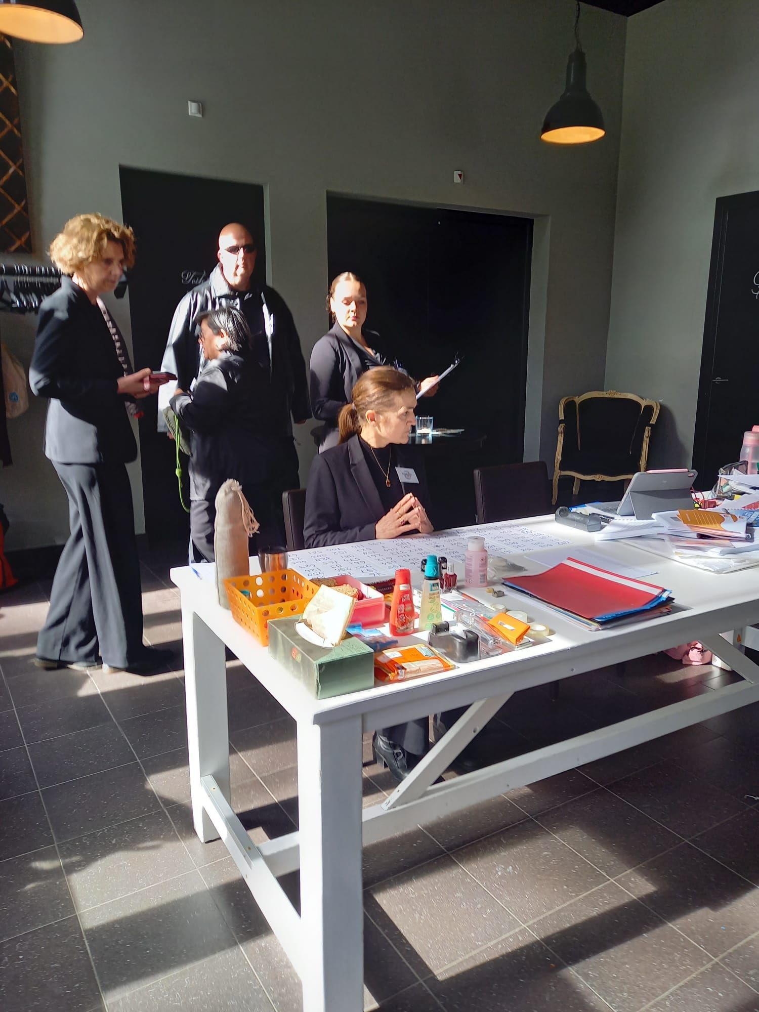 Acteurs  verzameld rond een knutseltafel