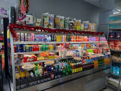 Refrigerated case of Latin drinks, sodas and snacks at Mini Market Mundo Latino