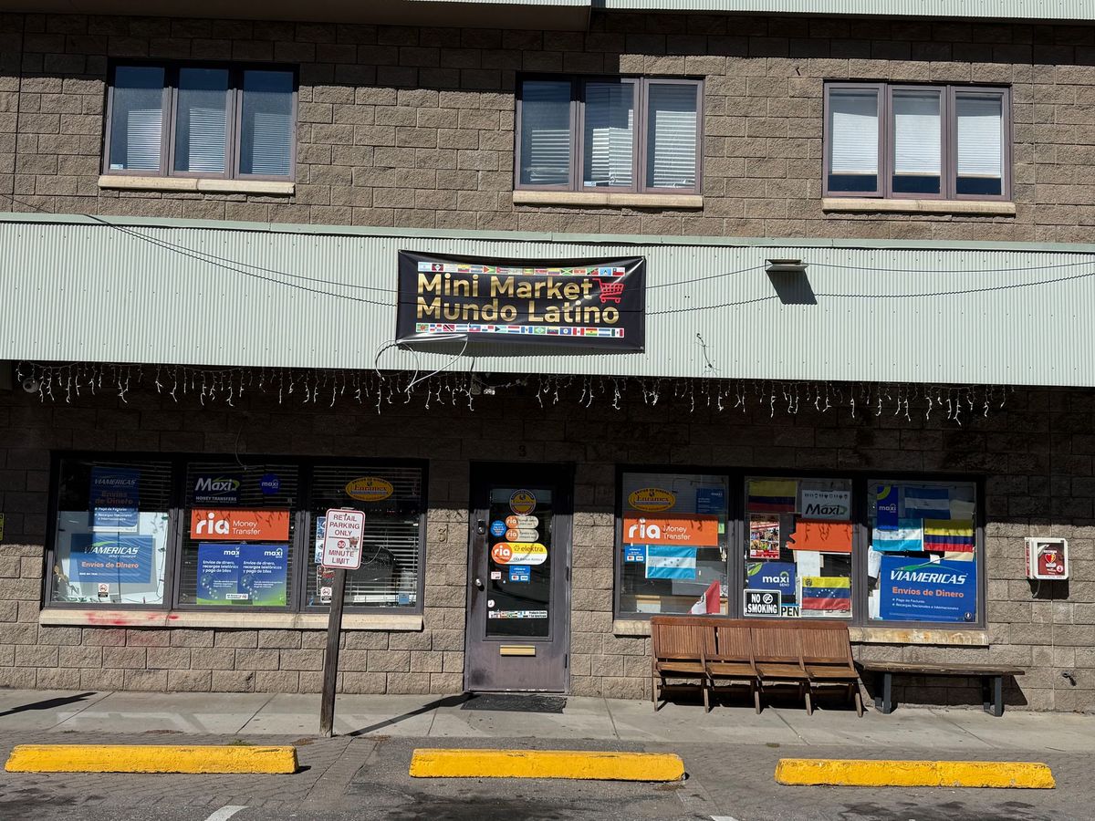 Storefront of Mini Market Mundo Latino in Avon with the black and gold banner