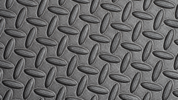A close up of a black rubber mat with a diamond pattern.