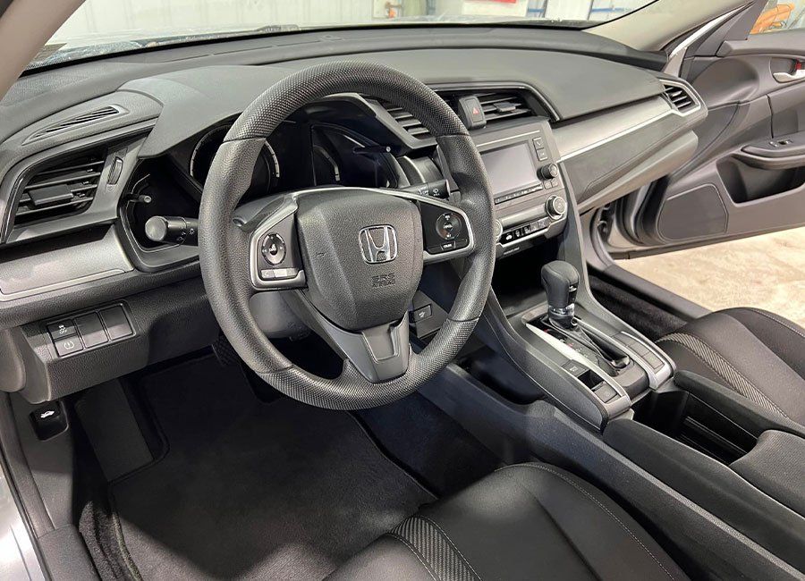 the interior of a honda civic is shown with the door open .