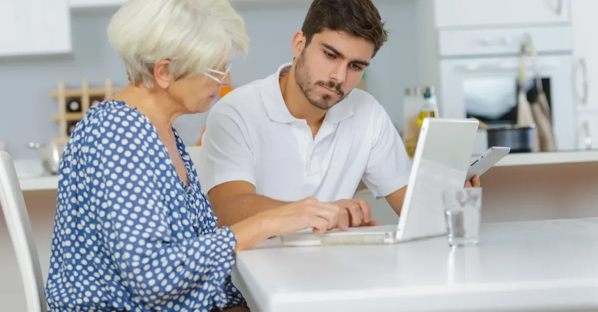 Woman and Man Looking at A Laptop Together — Rescuetech Computer And iPhone Repairs in Ballina, NSW