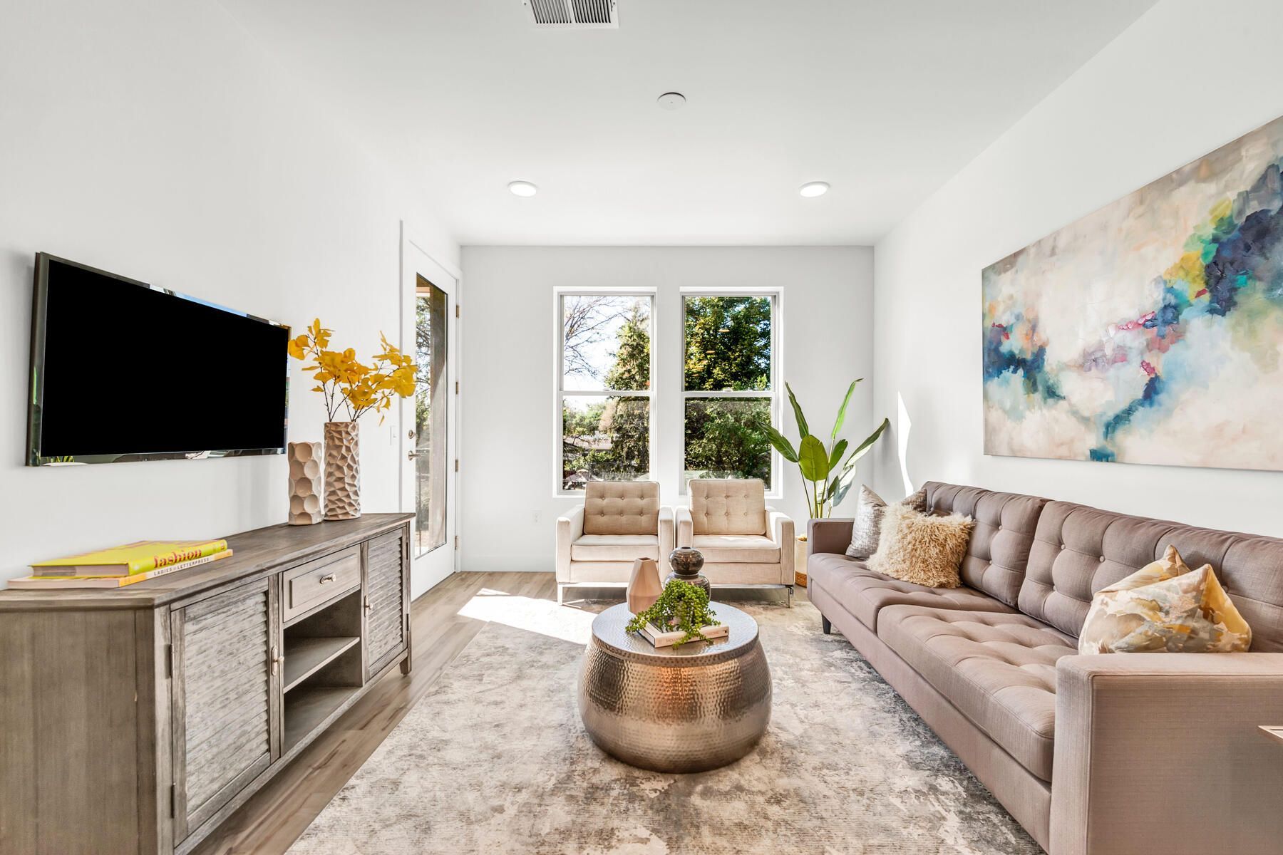 Living room with a gray couch, TV, and metal coffee table.