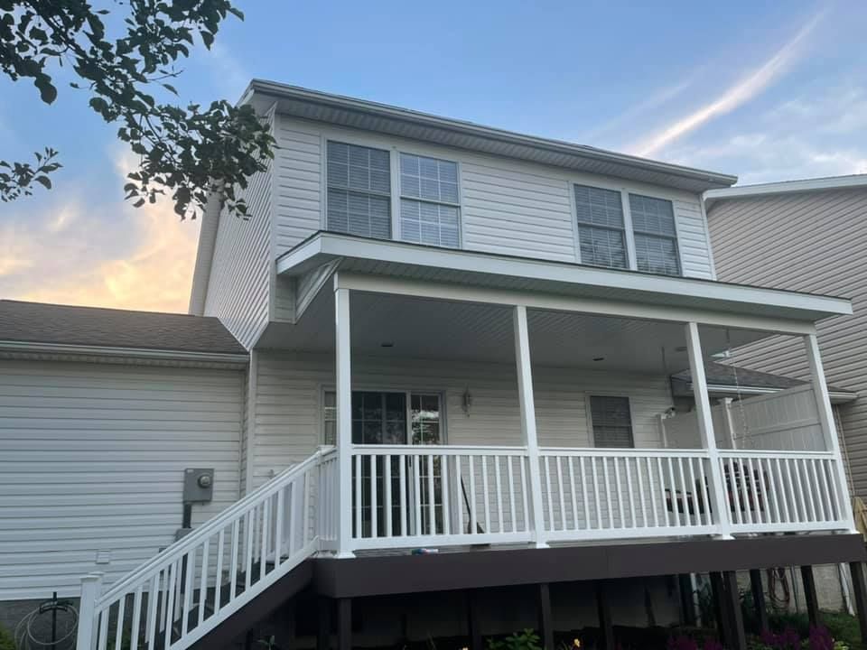 The back of a house with a porch and stairs.