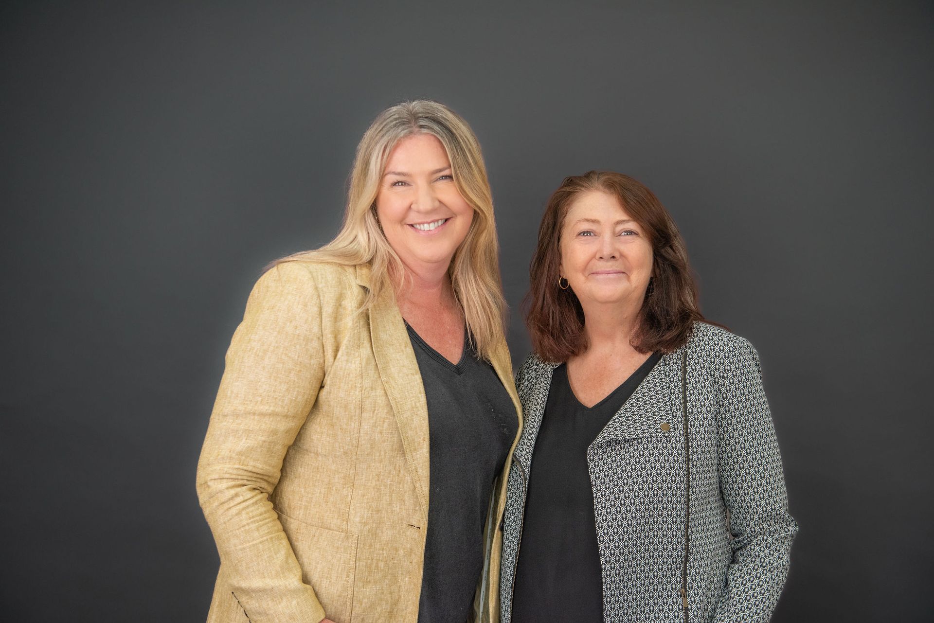 Two Woman Standing and Smiling — McNeilly Lawyers In Kempsey, NSW