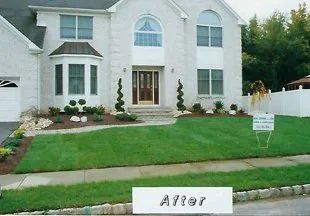 A white house with a sign in front of it that says after
