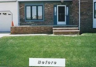 A before picture of a house with a sign in front of it.