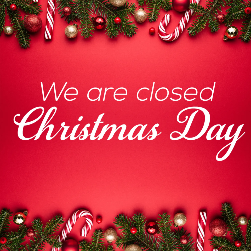 Text on a festive red background decorated with evergreen branches, ornaments, and candy canes says: We are closed Christmas Day.