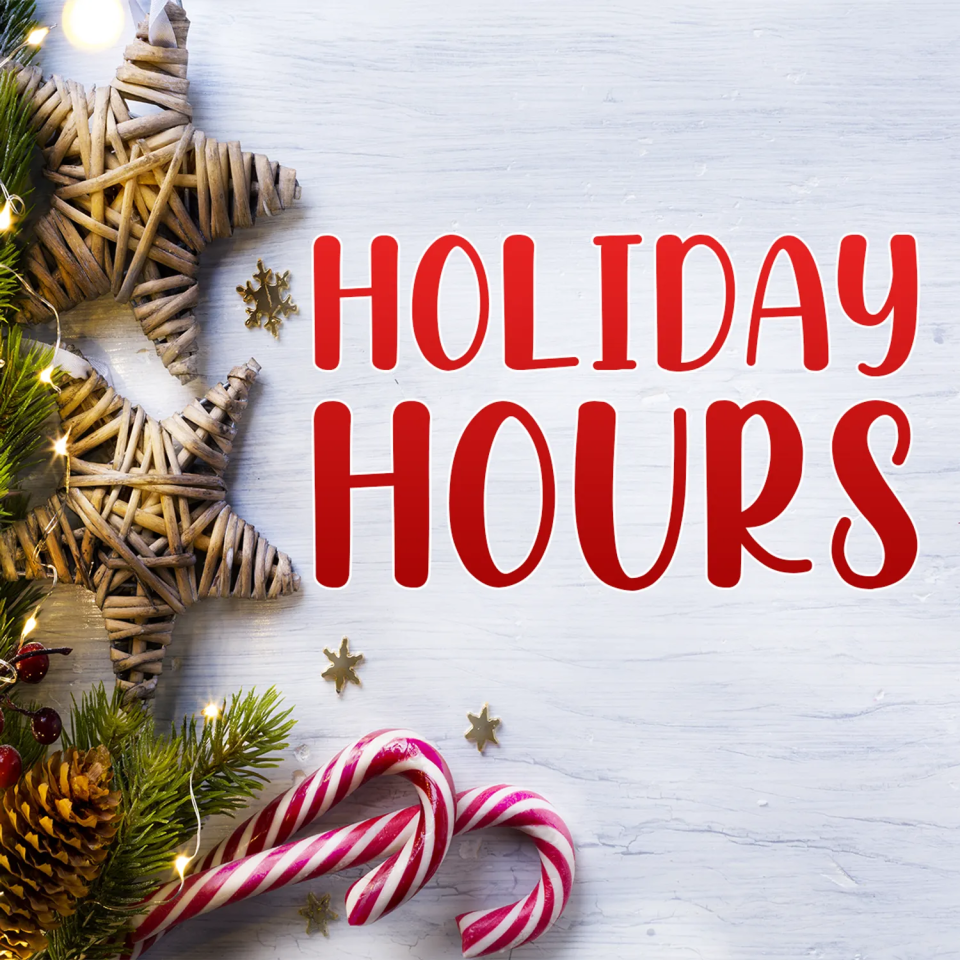 Holiday hours sign with red text on a white wooden background, decorated with wicker stars, pine branches, and candy canes.