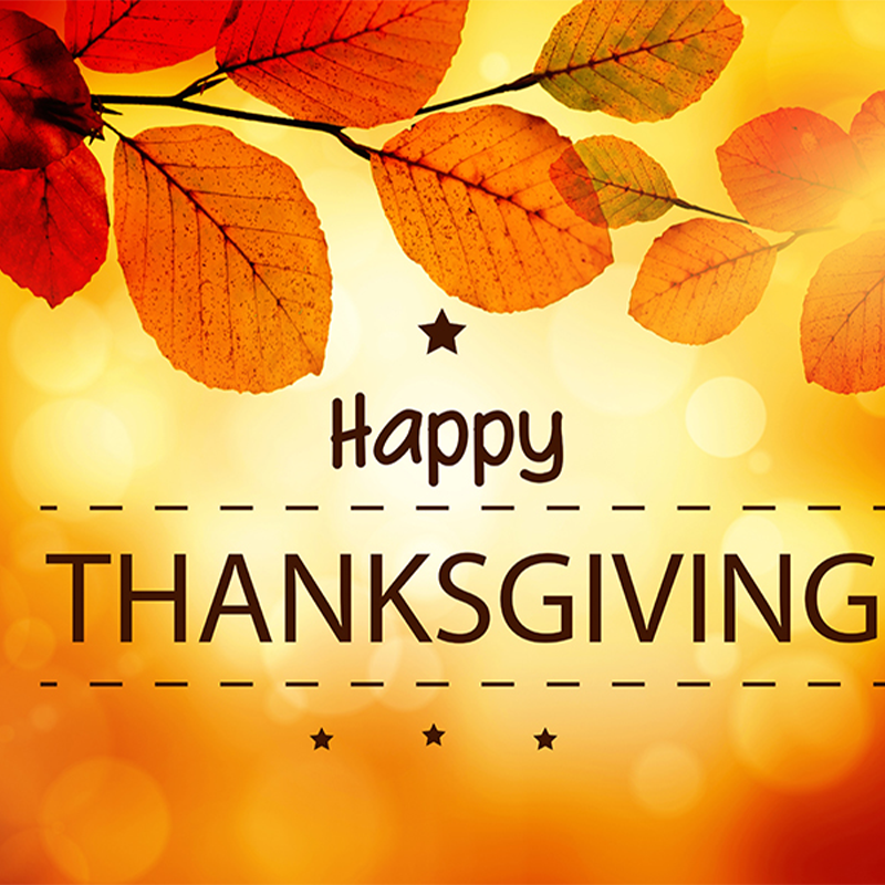 A Thanksgiving greeting card background with autumn leaves, a star, and a soft, golden, bokeh-lit backdrop.