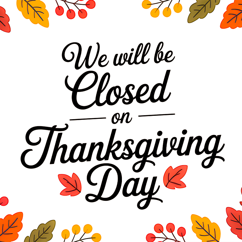A festive white sign with fall leaves and berries states: 