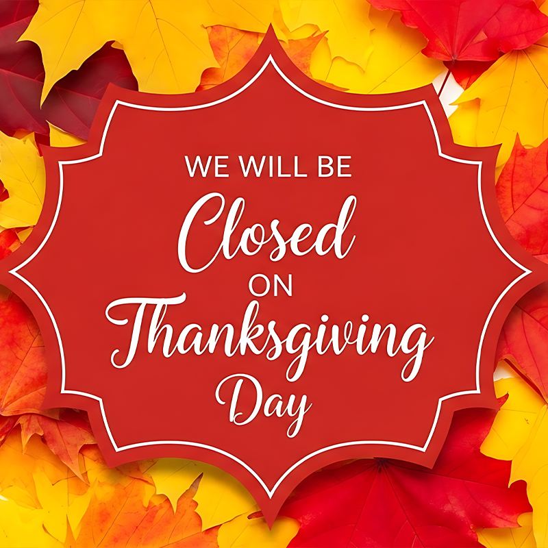 A red, decorative sign against a background of autumn leaves states: 