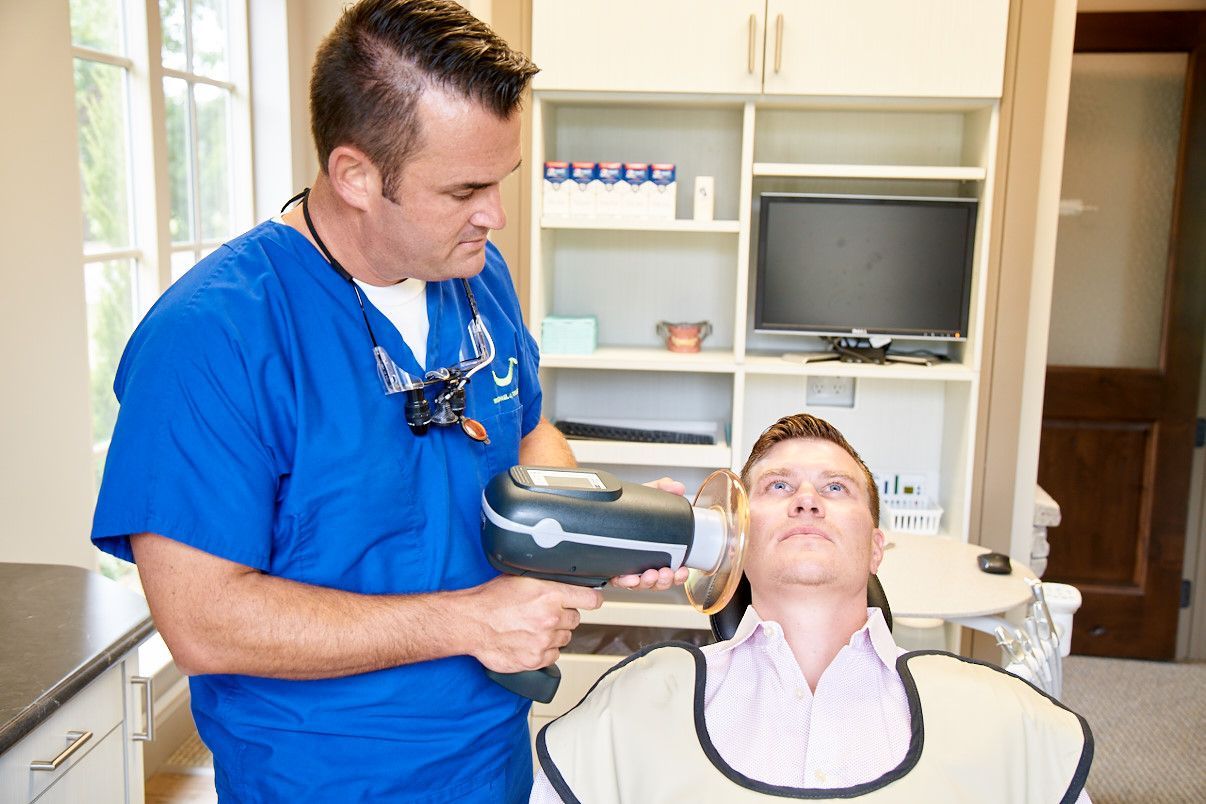 Dentist taking X-ray of patient in a dental office.