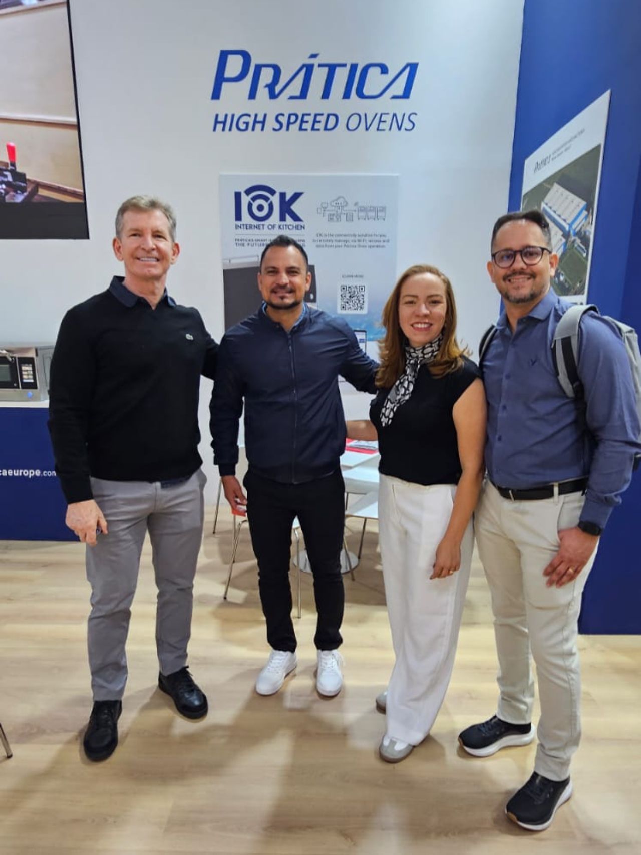 Four people pose near a 