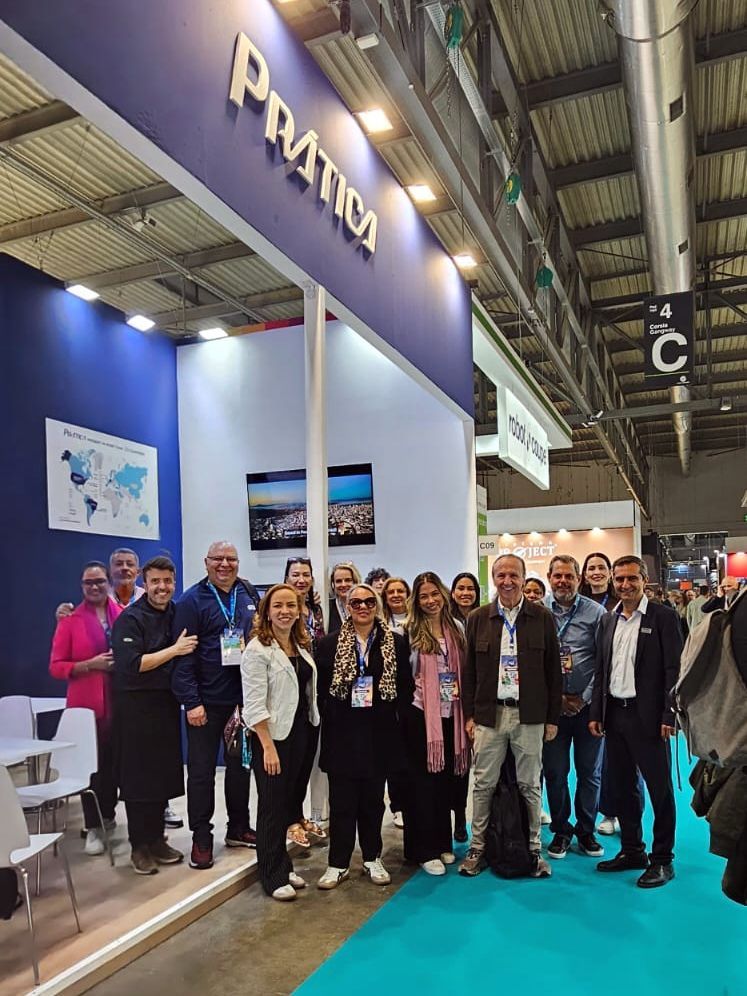 People pose in front of a blue and white 