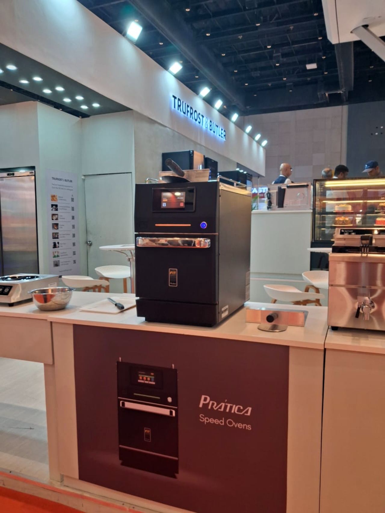 A commercial kitchen display with a black Promica Speed Oven.