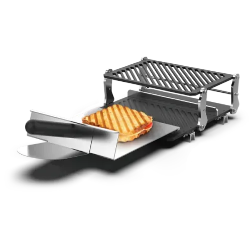 A grill with a sandwich on it and a spatula.