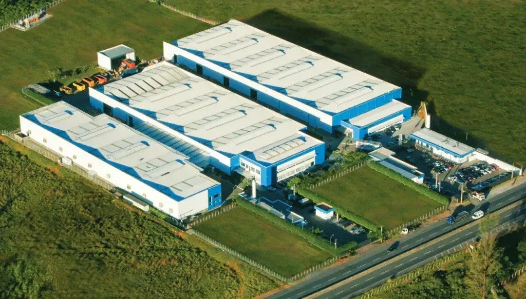 An aerial view of a large blue and white building