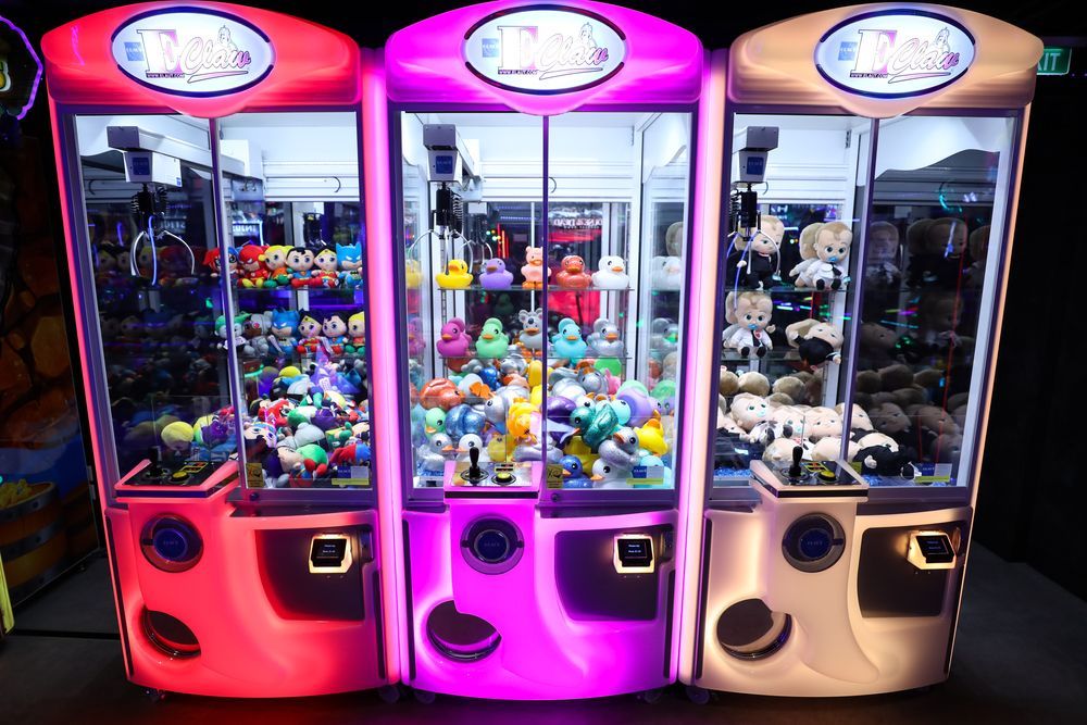 A person is playing a video game on an arcade machine.