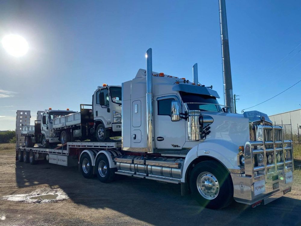 Transporting Two Isuzu Elf Truck — NQ Freighters In Bohle QLD