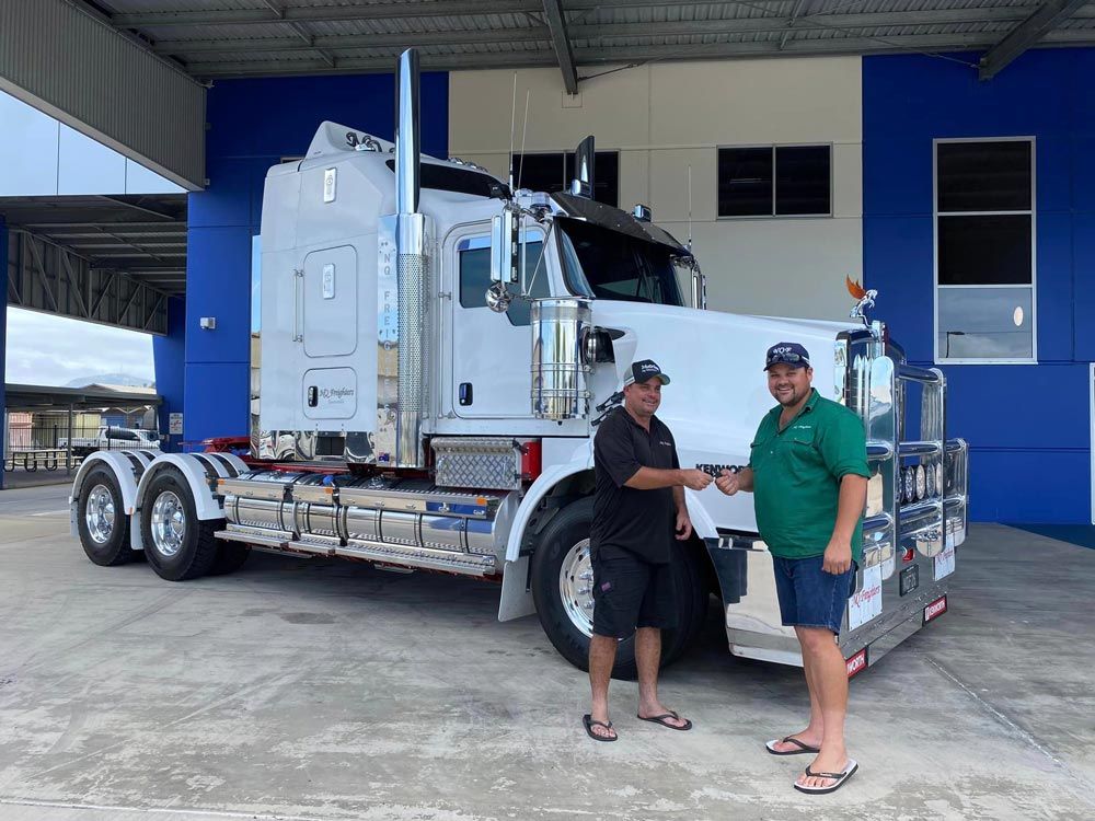 Two Men Are Smiling Giving The Keys Truck — NQ Freighters In Bohle QLD