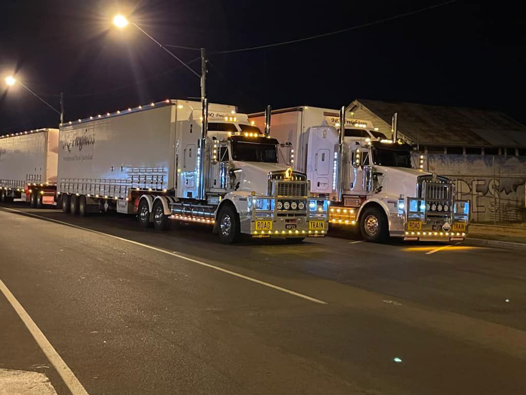 Two Road Train Truck On The Highway At Night — NQ Freighters In Bohle QLD