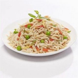 Orzo pasta salad with peas and tomatoes on a white plate.