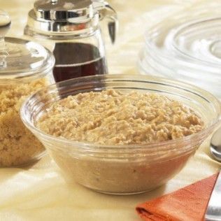 Bowl of oatmeal with brown sugar and syrup on a table.