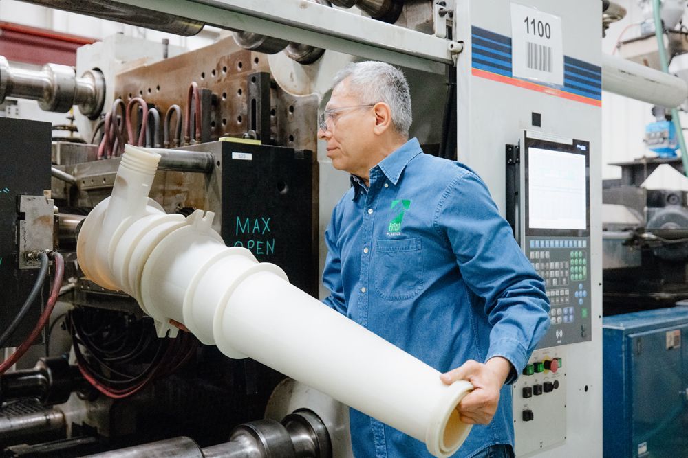 male member of the EnTech team managing the production of large-part injection molding