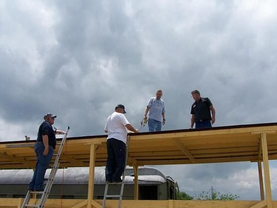 Volunteers Leo, John, Pete and Mike adding a roof to our ex-Missouri Pacific flat car.