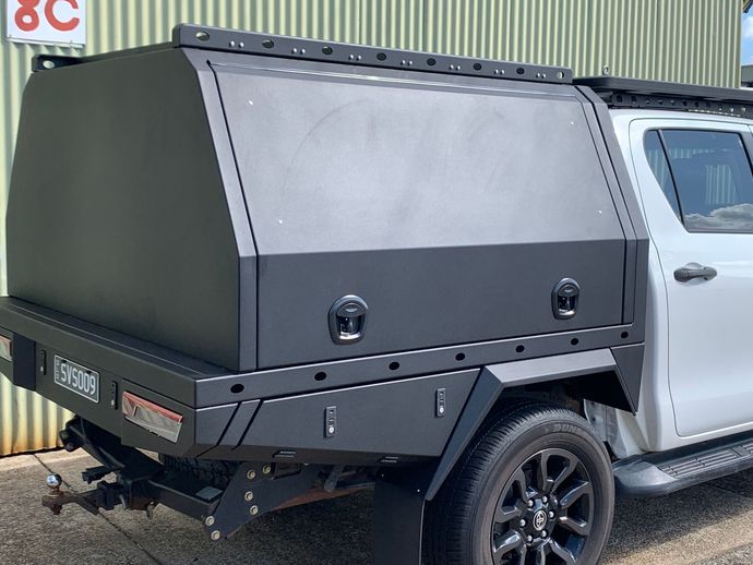 Black truck canopy with side panels mounted on a silver pickup, parked outdoors — Jensen Welding & Fabrication in Chevallum, QLD