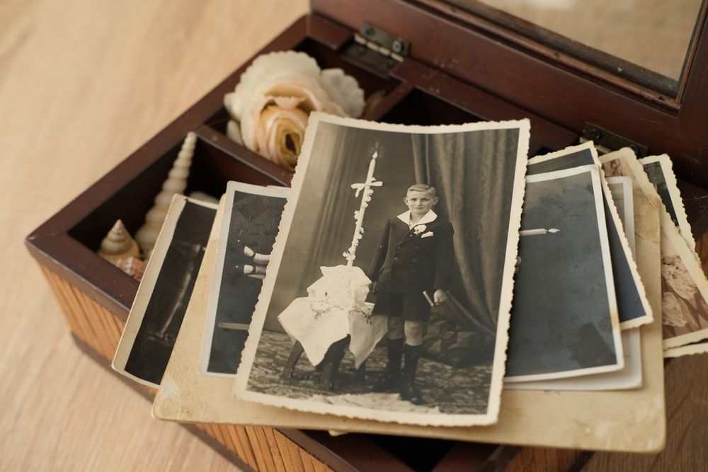A person is taking a picture of a man and a boy in a photo album.