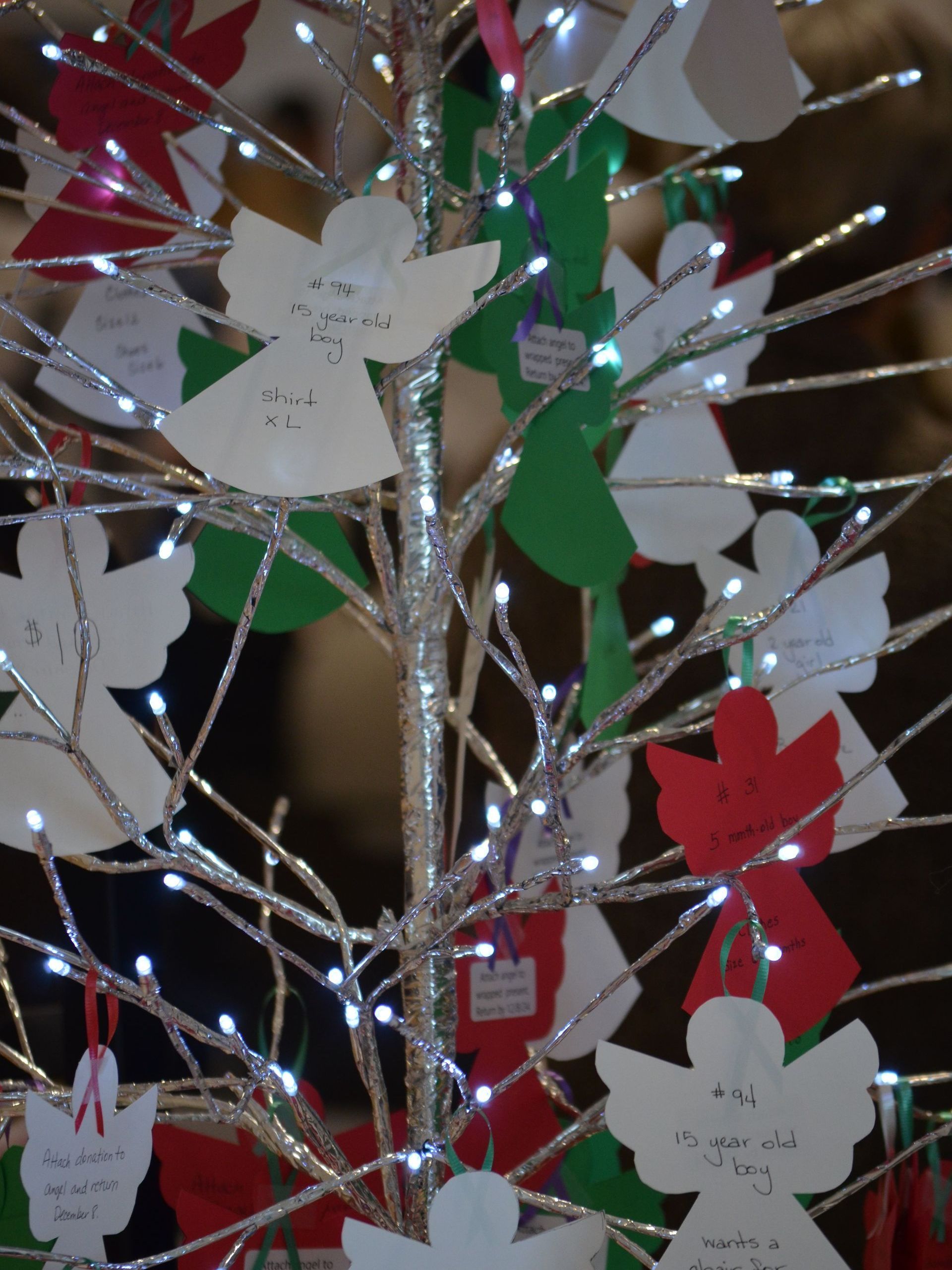 A christmas tree decorated with paper angels and lights